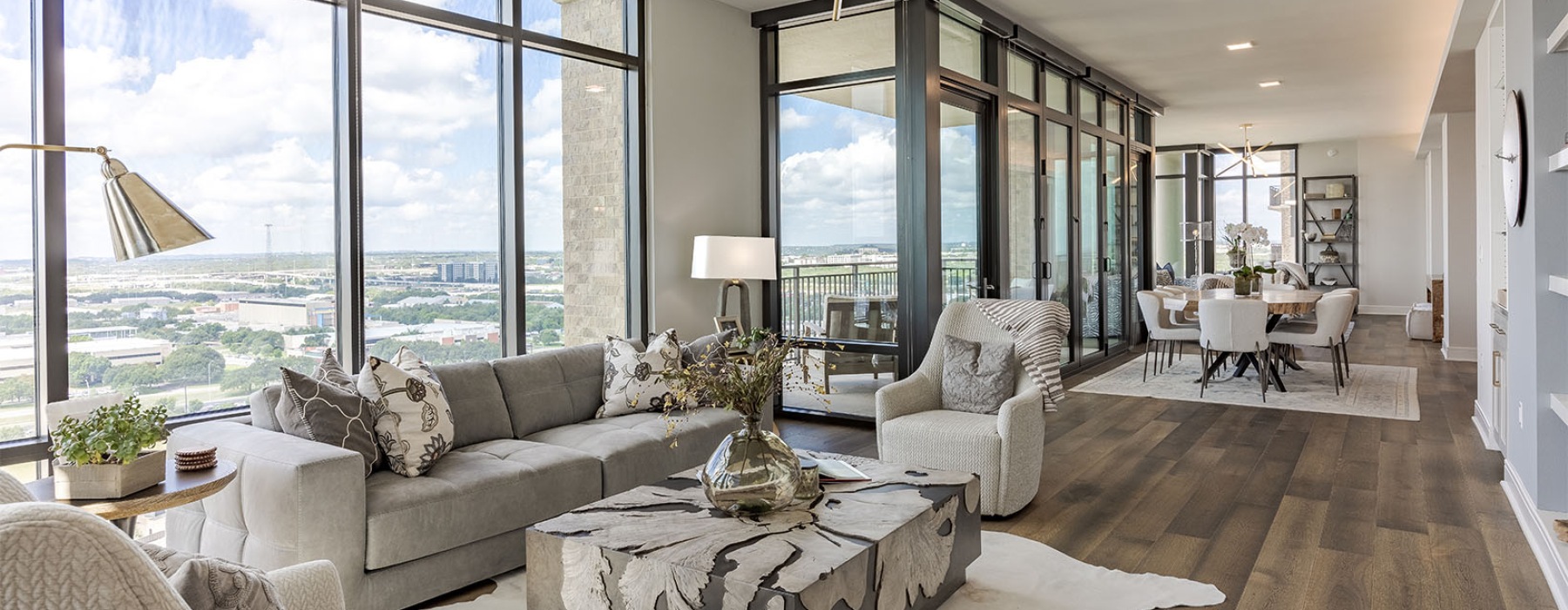 a living area with floor-to-ceiling windows